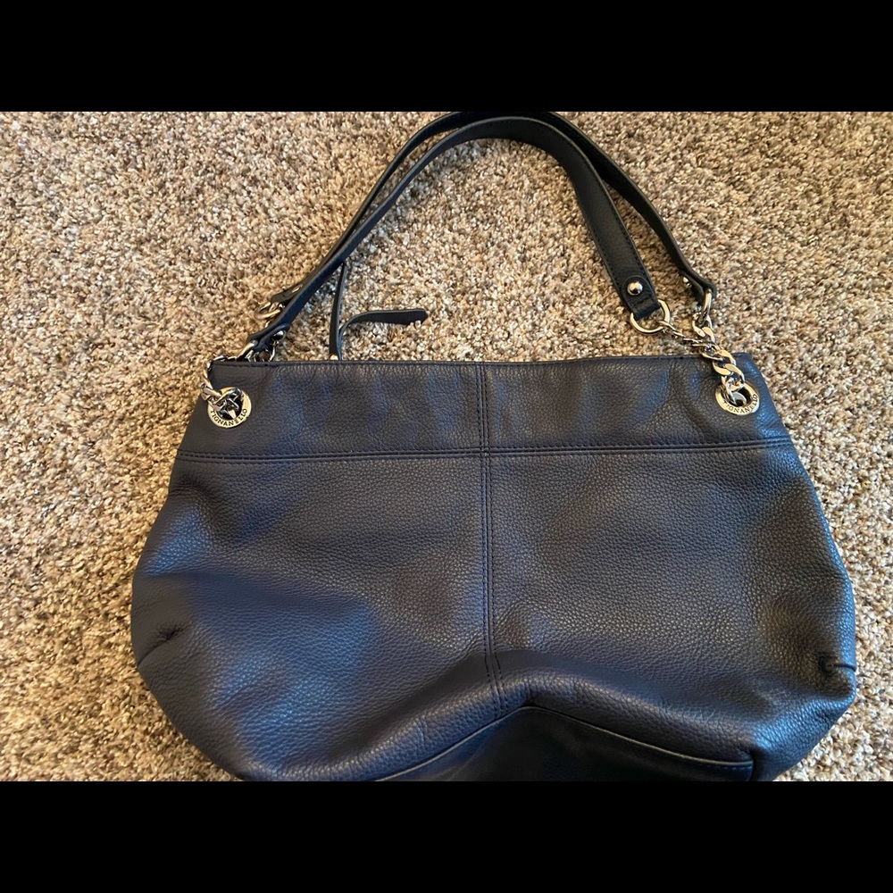 Navy blue leather Tignanello handbag. Satin interior. Hidden pocket detail